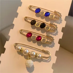 Detail of waist pin set with colorful gems and pearls for adjusting clothing fit