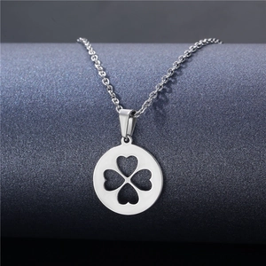 Close-up of a silver clover heart pendant on a minimalist stainless steel chain