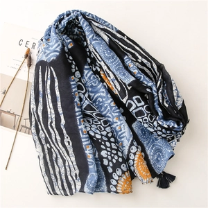 Ethnic blue and white pattern scarf with geometric motifs and decorative black tassels