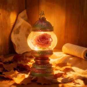 Vintage preserved pink rose glass dome lamp with warm light on rustic autumn background