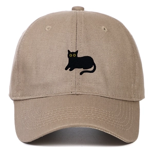Close-up of black cat embroidery with yellow eyes on khaki cotton twill baseball cap