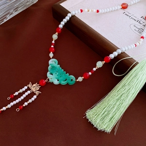 Detail of green Ruyi cloud pendant with white pearls and light green long tassel