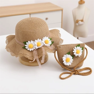 Detailed set of woven straw hat and matching crossbody bag with daisy floral accents