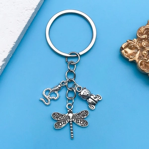 Retro silver keychain featuring snake, bear, and dragonfly charms with detailed textures