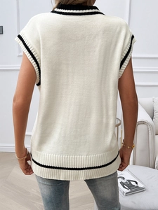 Rear view of white knit vest featuring contrast black stripe edges and loose fit design