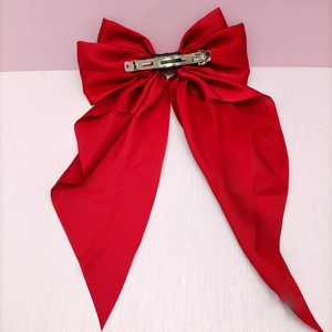Detailed back view of red satin bow hair clip with a handmade metal spring clip