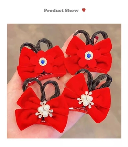 Detail of red velvet bow hair clips for girls featuring faux pearls and blue rhinestones