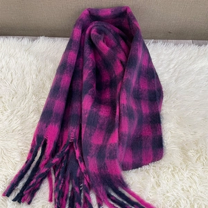 Winter plaid scarf featuring rose pink and black check pattern with stylish fringe