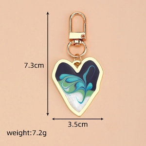 Detail view of heart keychain with blue fluid art and dimensions 7.3cm x 3.5cm