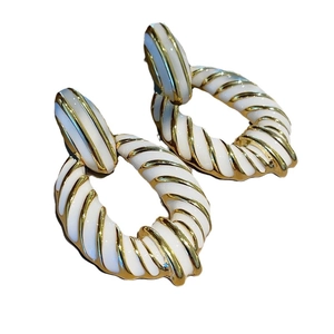 18K gold plated zebra pattern twist earrings with white enamel in a retro geometric style
