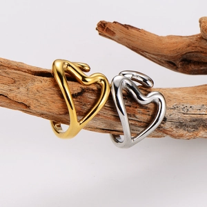 Minimalist hollow heart open rings in gold and silver finish on a wooden branch