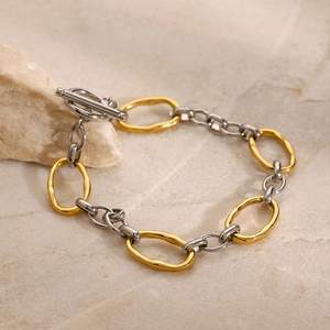 Detail of two-tone stainless steel chain bracelet with a classic OT toggle clasp design