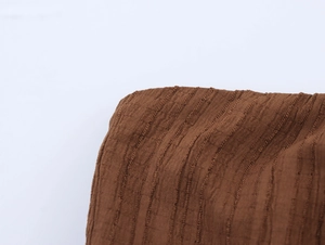 Detail of caramel vacation set showing 3D textured vertical grain and pleated fabric