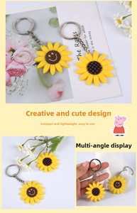 Macro detail of yellow sunflower PVC keychain showing metal ring and smile design