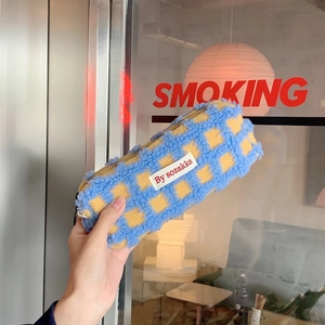 Close-up of blue and yellow waffle texture fleece pencil case with gold zipper detail