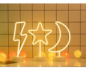 Detailed view of warm white LED neon lamps in moon, star and lightning shapes on round bases