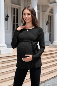 Detail of black rib-knit maternity sweater featuring a matching waist tie and crew neck