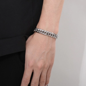 Detailed view of silver polished double-link curb chain bracelet on a wrist