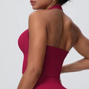 Detail of deep magenta halter backless yoga bra showing the ribbed seamless fabric texture