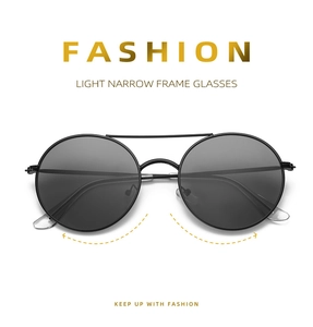 Detail of lightweight black round metal sunglasses with a vintage double bridge design