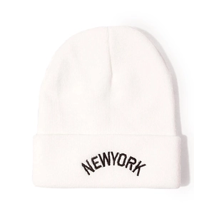 Detailed view of white knitted beanie with black NEW YORK embroidery and folded cuff