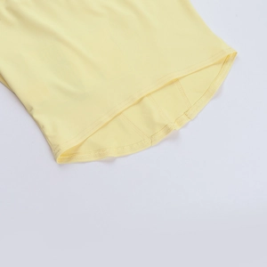 Detail view of double-stitched curved hem on a bright yellow long sleeve t-shirt