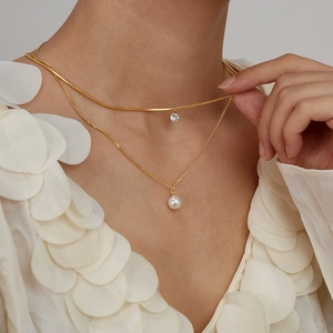 Double-layered gold titanium steel necklace with a single zircon and round pearl pendant