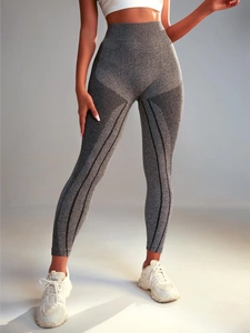 Detail of high-waisted seamless yoga leggings with gray honeycomb texture and sculpting lines
