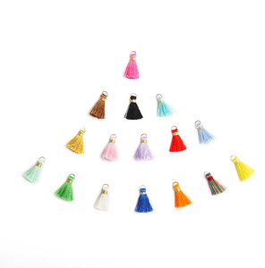Colorful mini tassels with metal rings arranged in a pyramid shape for DIY crafts