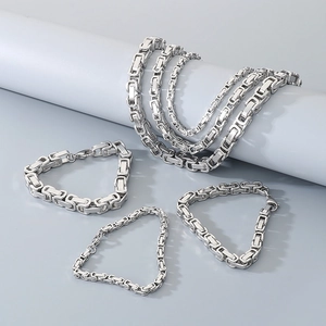 Detailed view of silver Byzantine link chain necklaces and bracelets set in 304 stainless steel