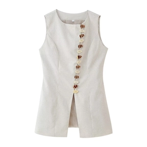 Detail of the sleeveless top neckline with asymmetrical placket and marble buttons