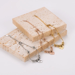 Three-color stainless steel snake chain bracelets with LOVE heart pendants on stone