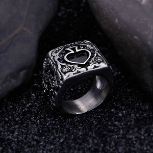 Macro shot of retro spade seal ring with gothic engraved scroll patterns on band