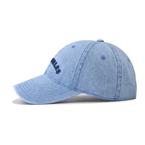 Detail of washed blue denim baseball cap featuring vintage Los Angeles 3D embroidery