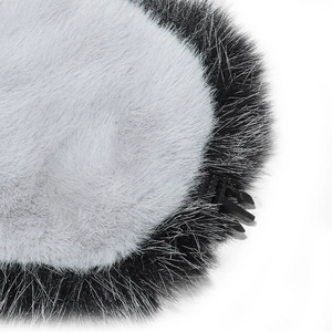 Detail view of plush faux fur cap showing black and white fur texture and side buckle