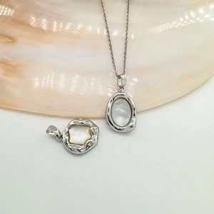 18K plated silver necklace featuring oval white shell pendant displayed in a seashell