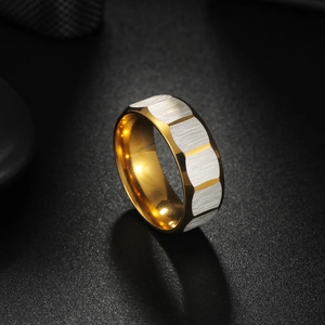 Macro detail of brushed silver finish and golden polished inner band on geometric ring