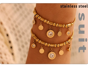 Detailed close-up of golden stainless steel bracelet set with Roman numerals and crystals