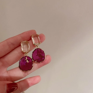 Detailed close-up of French vintage silver needle earrings with purple crystal and resin
