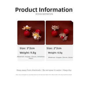 Detail view of 18k gold plated flower stud earrings with red beads and white zircon stones