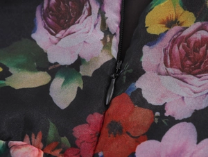 Detail of floral organza dress showing hidden zipper and pink rose textile print