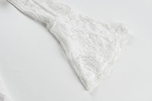 Detail of elegant white floral lace flared sleeves with delicate scalloped edges