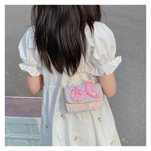 Detail of pink mermaid tail sequins and pearl handle on a kids' crossbody bag
