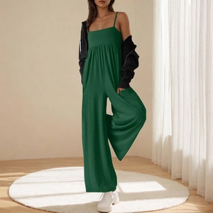 Detail of forest green jumpsuit featuring thin straps and pleated high waist design
