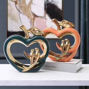 Modern ceramic apple lovebird sculpture in dark green and orange for elegant home decor