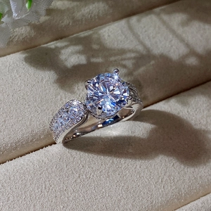 Macro shot of a brilliant round-cut zircon ring with pavé diamonds in a jewelry box