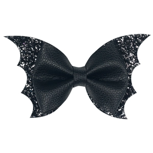 Detail view of black glitter bat wing hair clip with textured faux leather finish