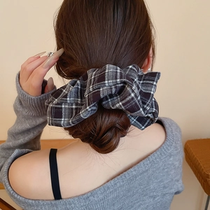 Detail shot of a large plaid scrunchie in black and white check pattern on a ponytail