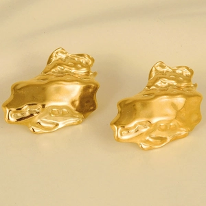 Macro detail of 18K gold stainless steel earrings with unique textured irregular surface
