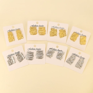 Detail of 8 pairs gold and silver hammered geometric earrings on display cards